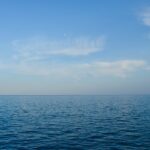 blue body of water under white clouds