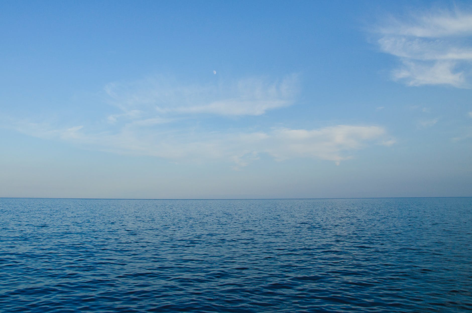 blue body of water under white clouds