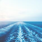 blue body of water under clear blue sky