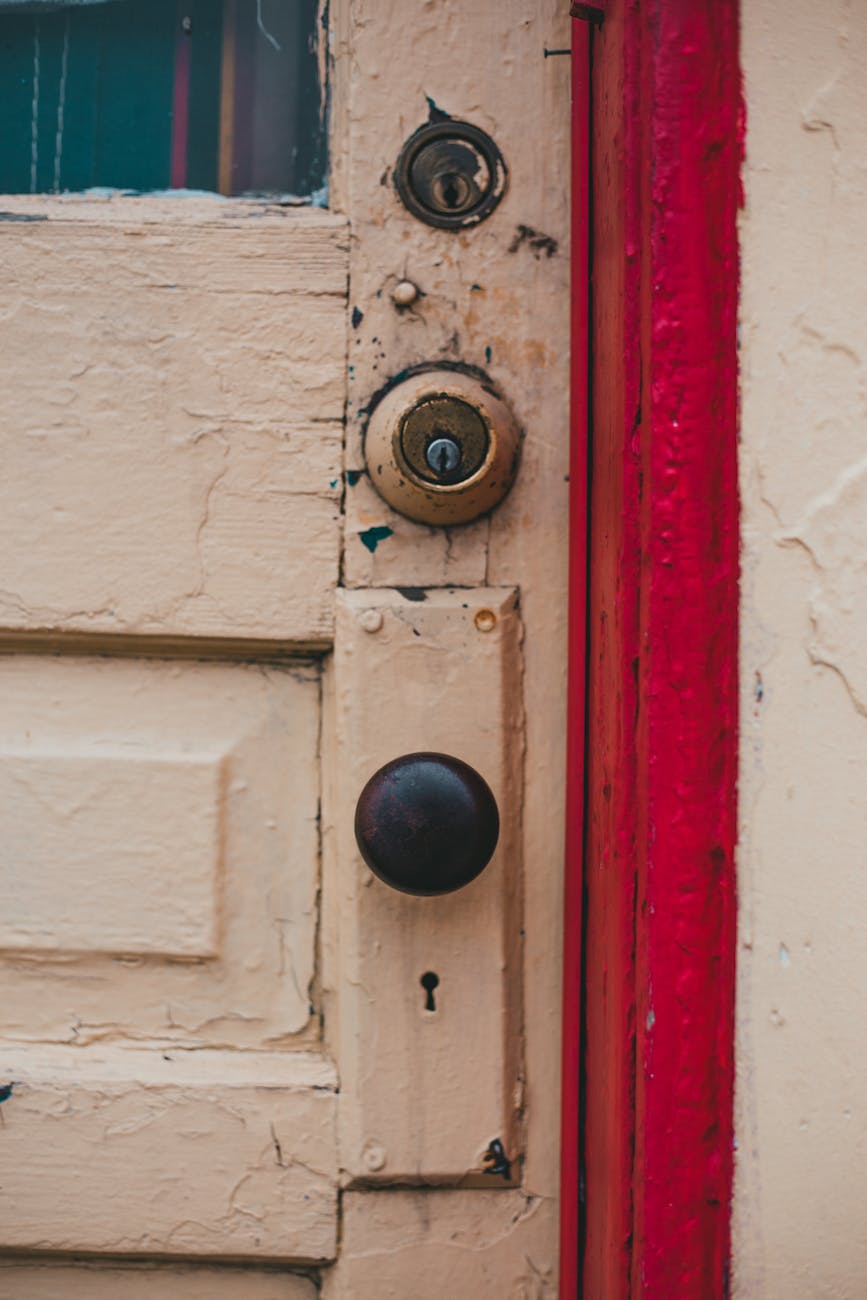 aged yellow door with red cant