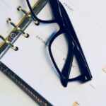 black framed wayfarer style eyeglasses on white surface