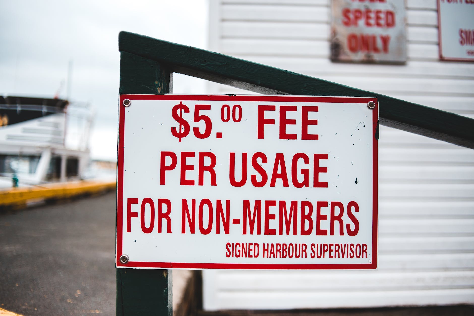 signboard with entrance price information outside harbor cottage