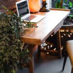 himalayan salt lamp near laptop on wooden table