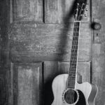 brown and black cut away acoustic guitar
