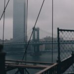 manhattan bridge and one manhattan square skyscraper on a rainy day