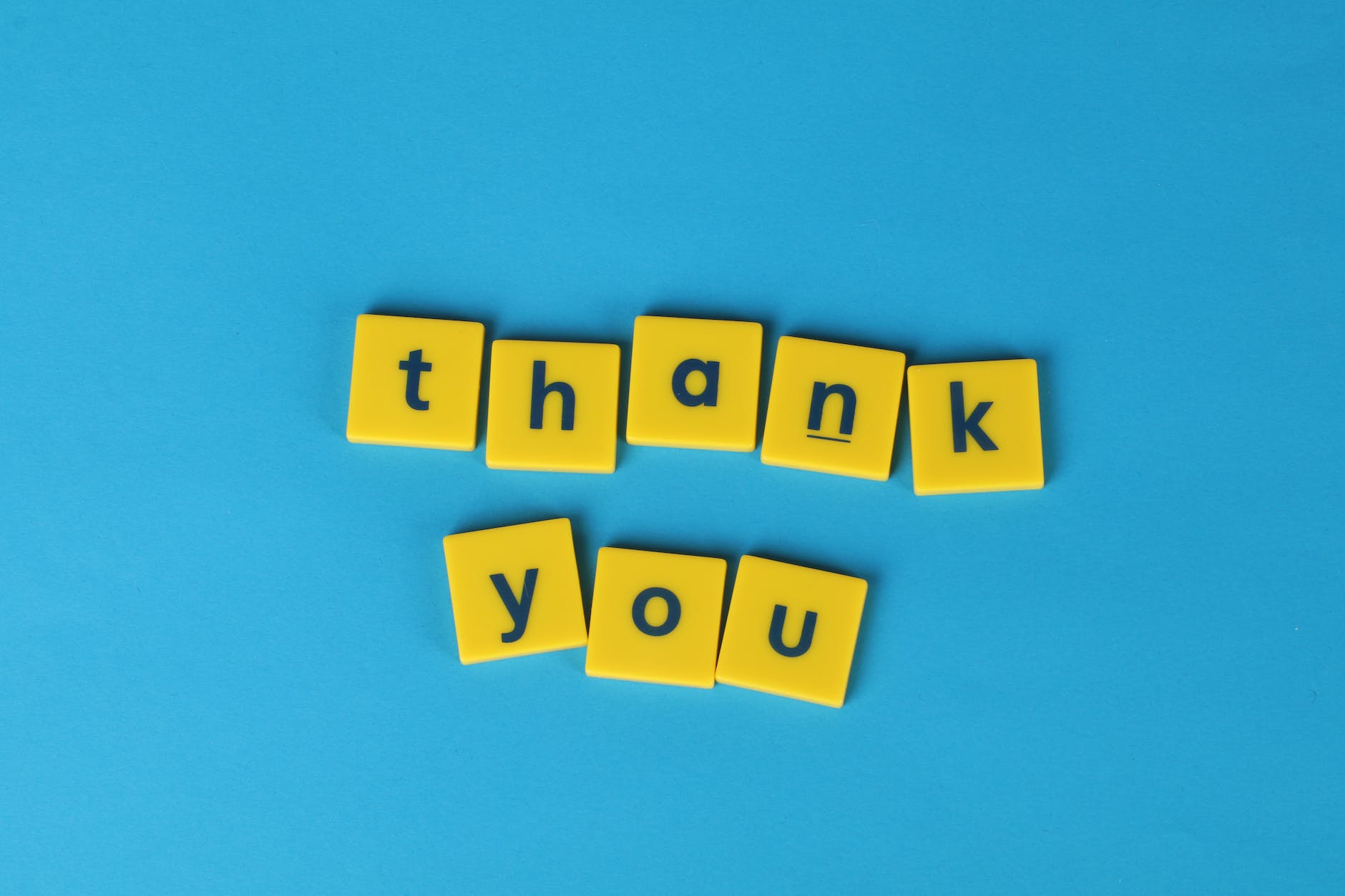 yellow letter tiles on blue background