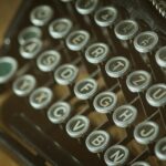 shallow photoghrapy of black and gray type writer keys