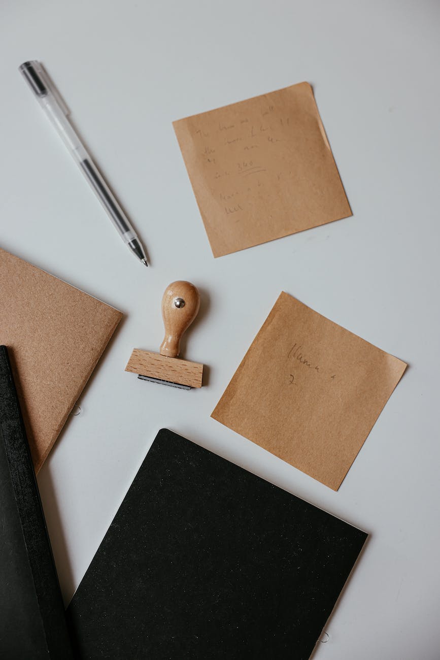 pen and a stamp on gray surface