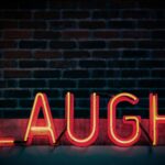 laugh neon light signage turned on