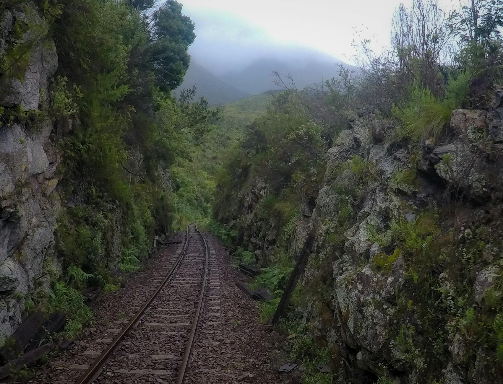 train track on rocky mountainside